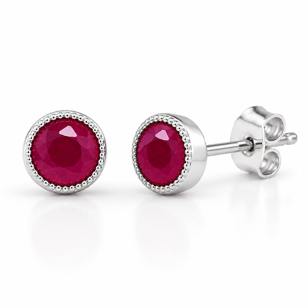 Macro view of 5mm round natural ruby gemstones and detailed silver setting