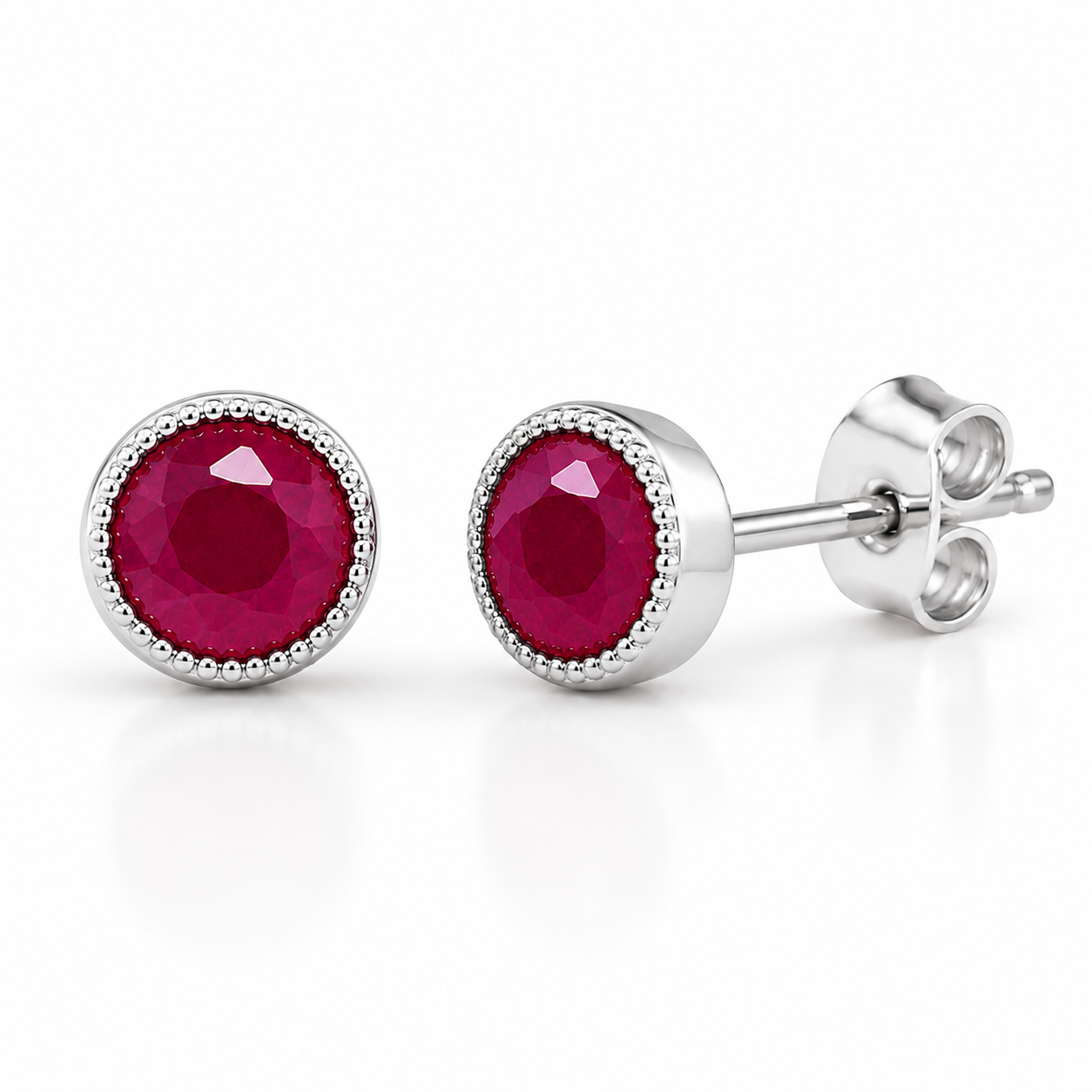 Macro view of 5mm round natural ruby gemstones and detailed silver setting