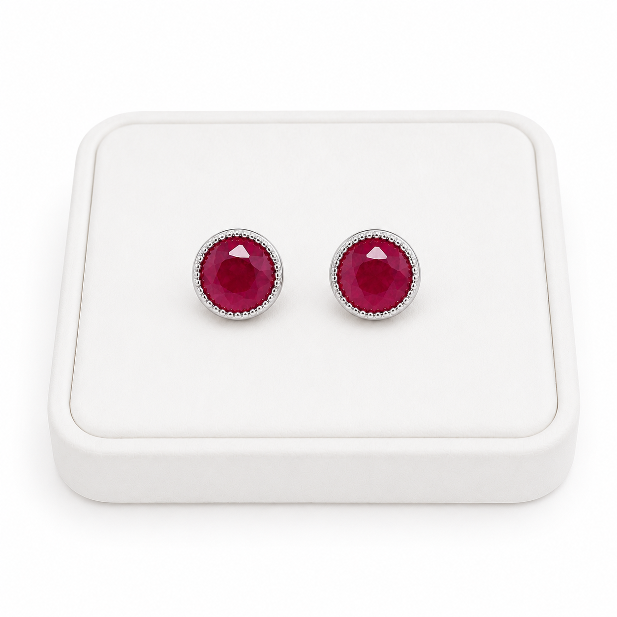 Phimsera 5mm natural ruby stud earrings displayed on white jewelry tray