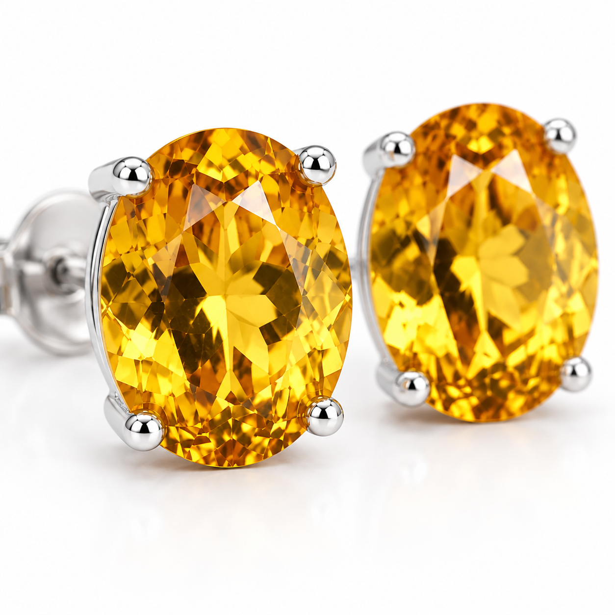 Macro close-up of 7x9mm oval citrine gemstones showing golden color and faceting