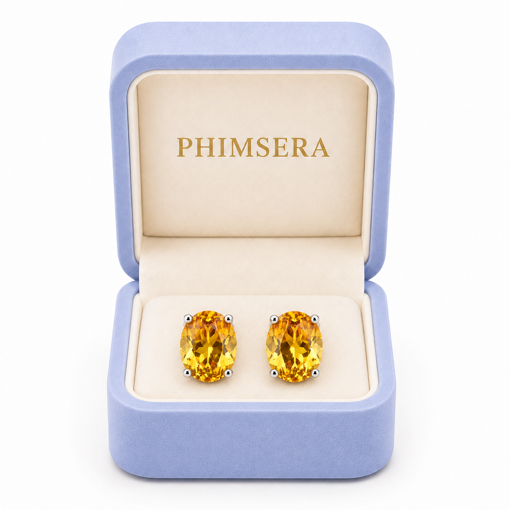 Natural 7x9mm citrine stud earrings displayed in Phimsera jewelry gift box