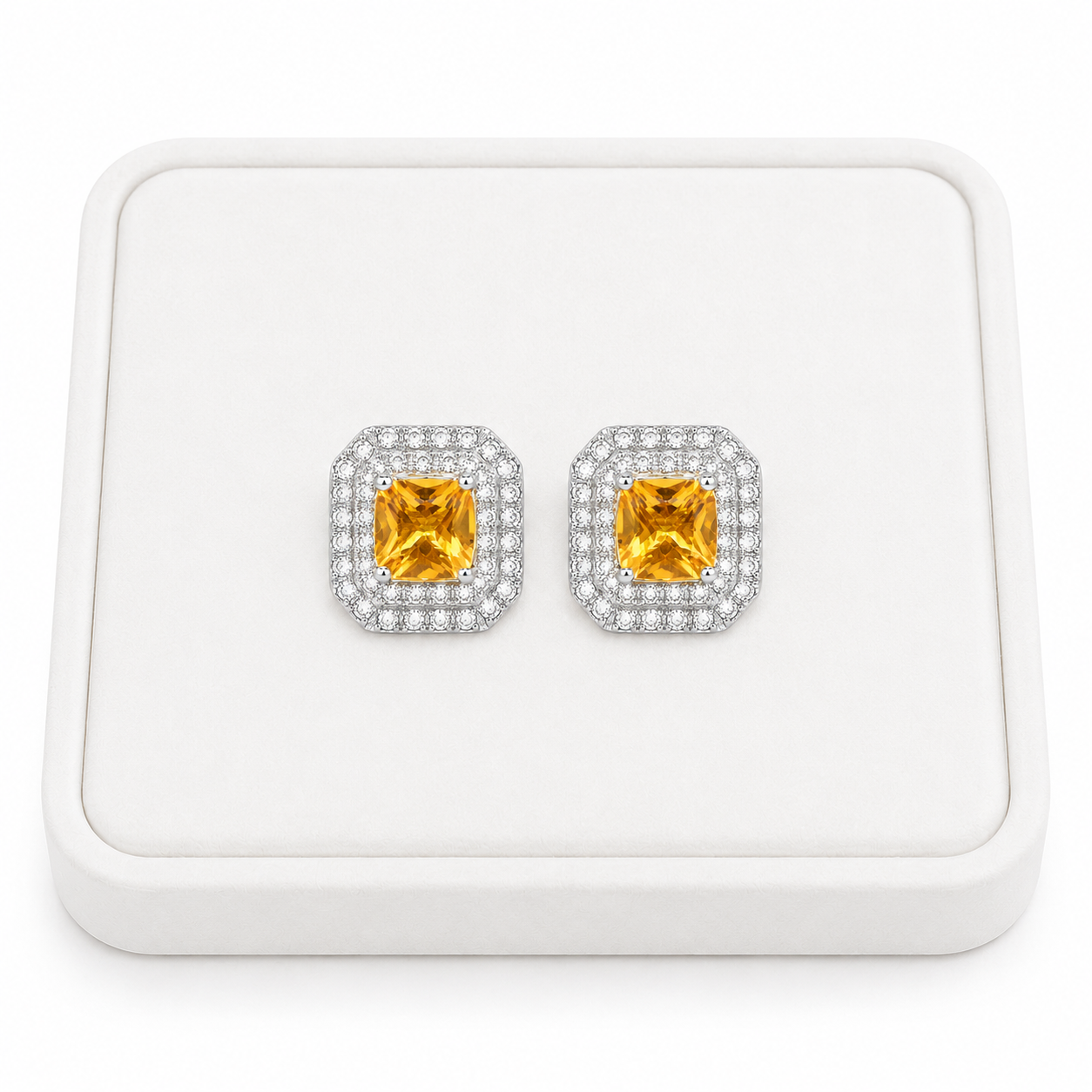 Natural 4mm citrine double halo earrings displayed on white jewelry tray