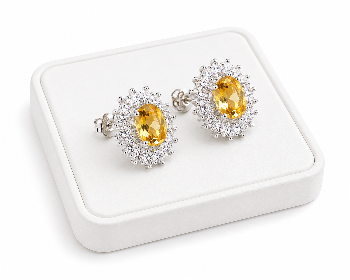 Phimsera natural citrine stud earrings displayed at an angle on a white jewelry tray