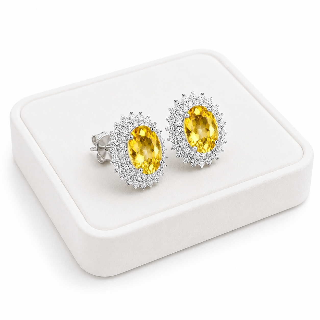 Natural citrine halo stud earrings displayed on a luxury white jewelry tray