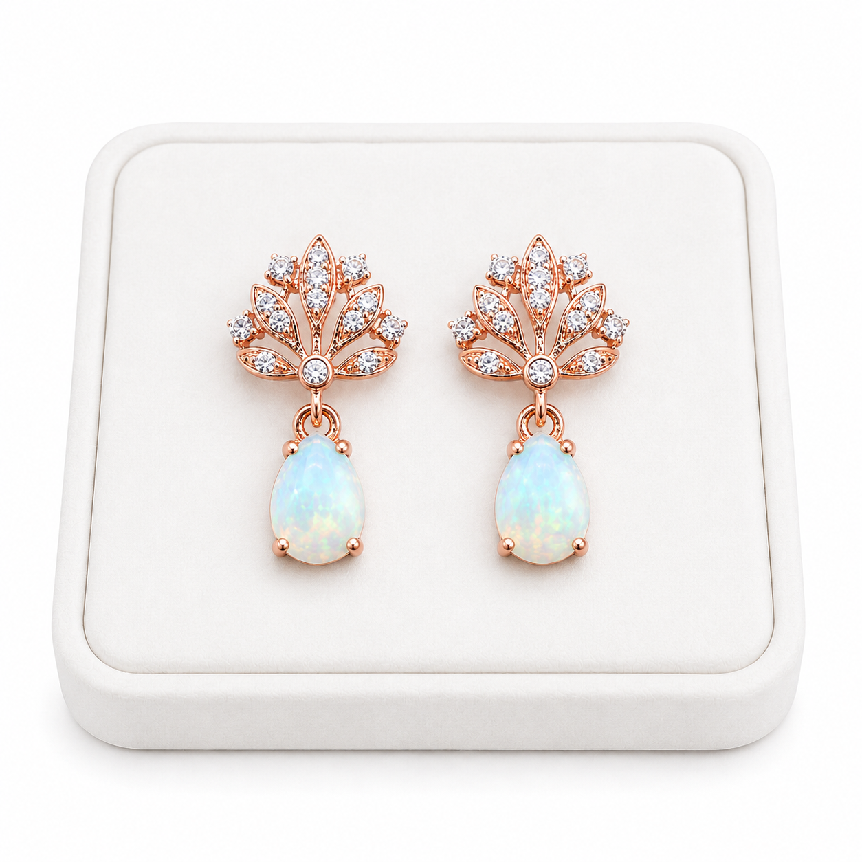 Phimsera 5x7mm natural fire opal drop earrings displayed on a white jewelry tray