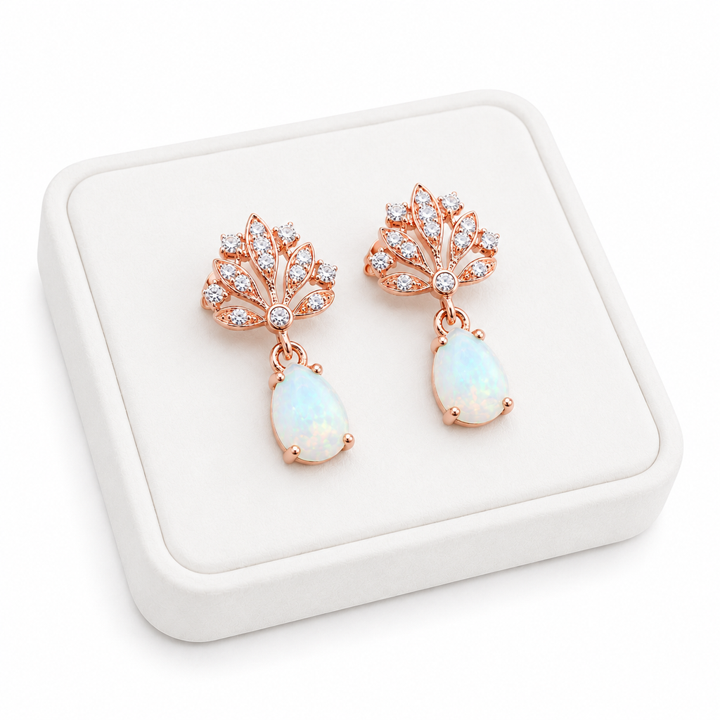 Phimsera 5x7mm natural fire opal drop earrings displayed on a white jewelry tray