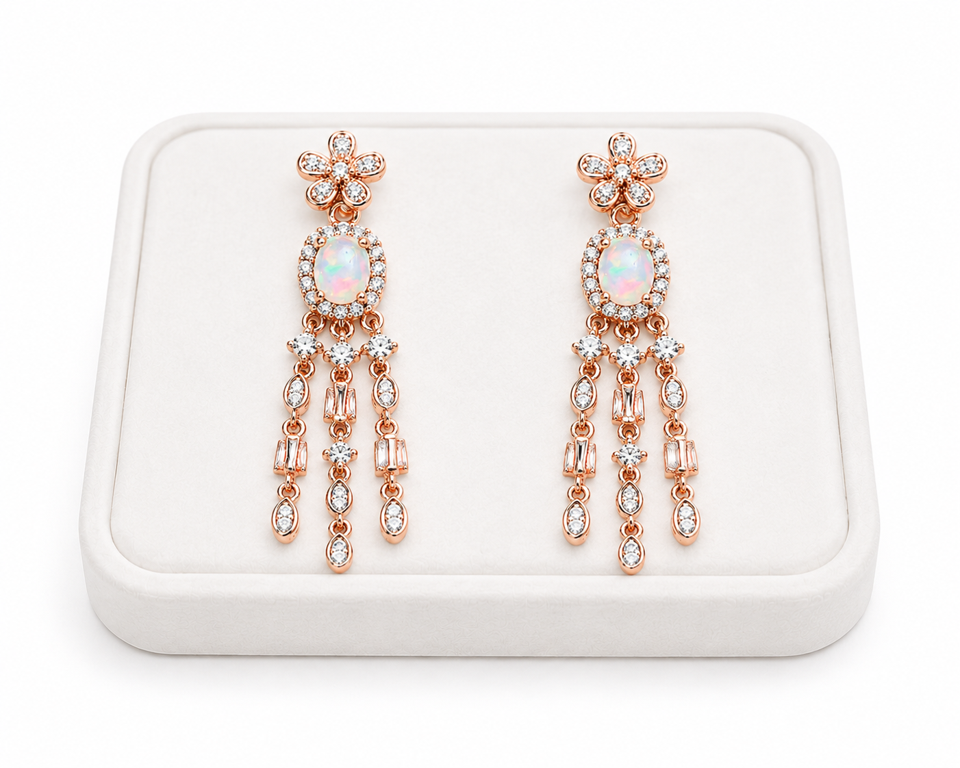 Natural fire opal chandelier earrings displayed on a white jewelry tray with 4x6mm oval opal gemstones