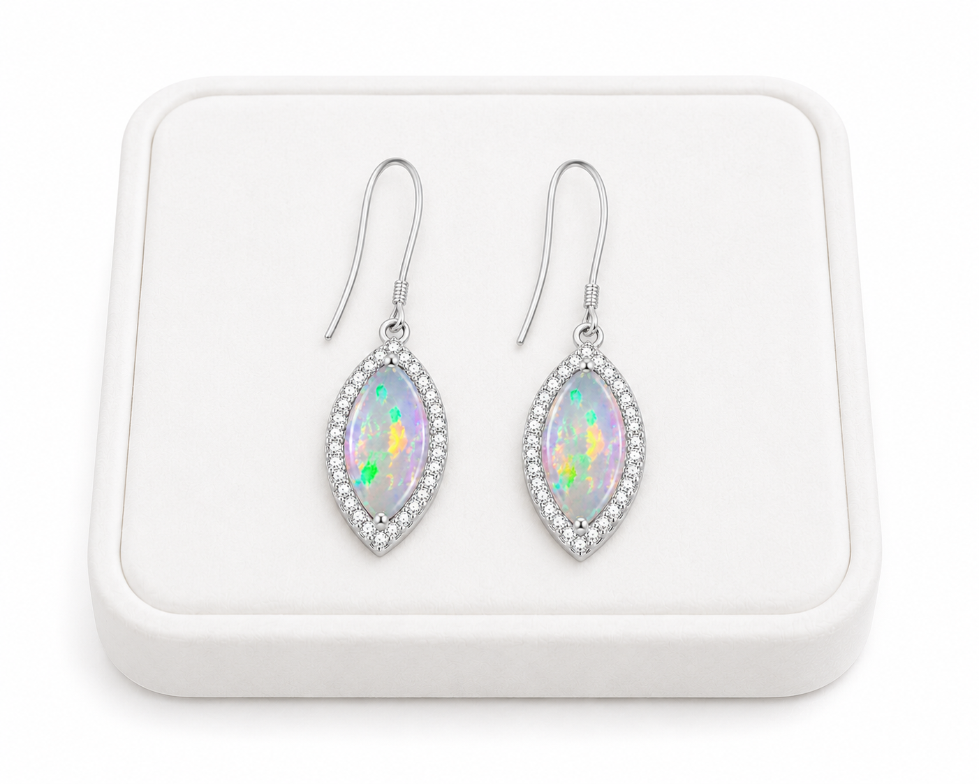 Natural fire opal marquise dangle earrings displayed on white jewelry tray