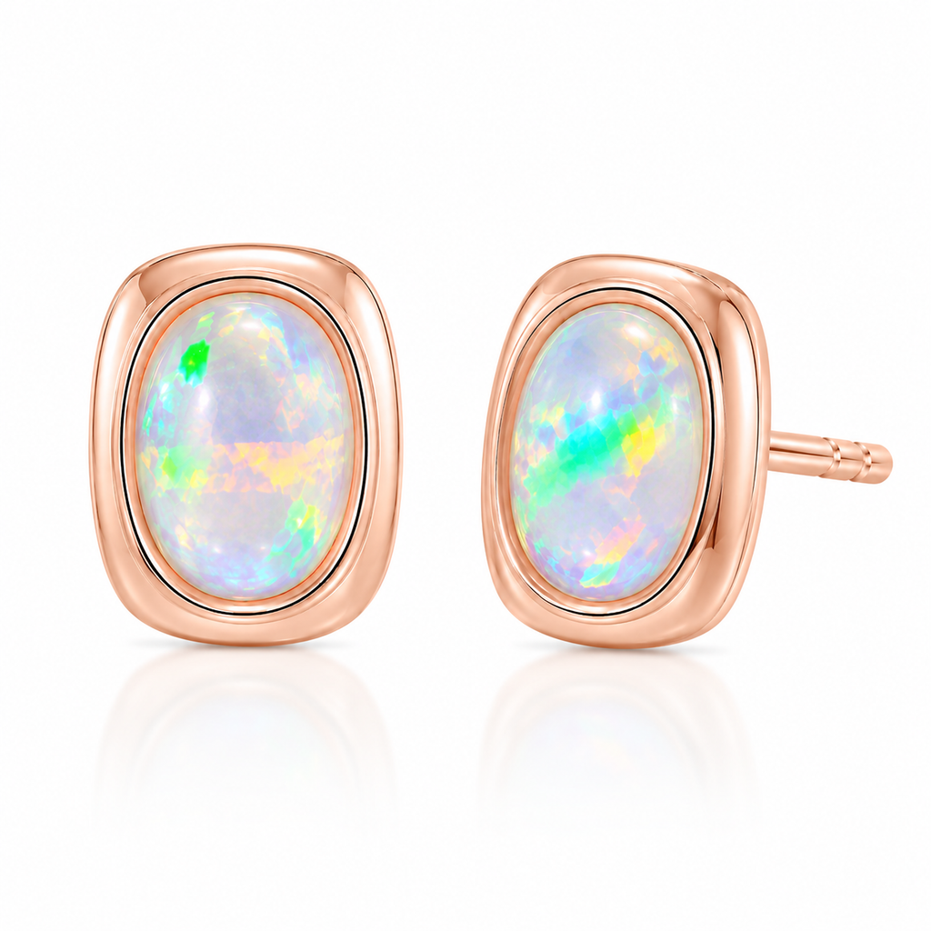 5x7mm natural fire opal stud earrings shown at a 45 degree angle with rose gold settings