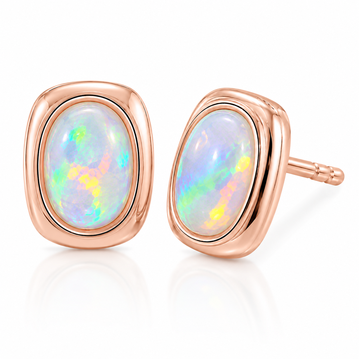 Macro close-up of natural 5x7mm fire opal earrings showing green yellow orange blue and pink play-of-color
