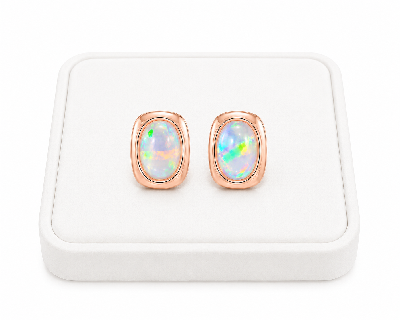 5x7mm fire opal earrings displayed at an angle on a luxury white jewelry tray