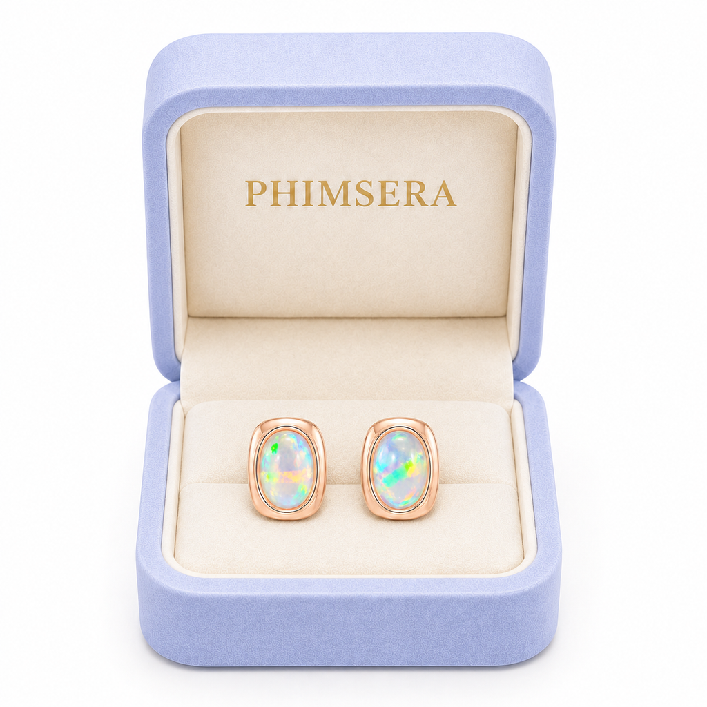 Phimsera 5x7mm natural fire opal stud earrings displayed in signature jewelry gift box