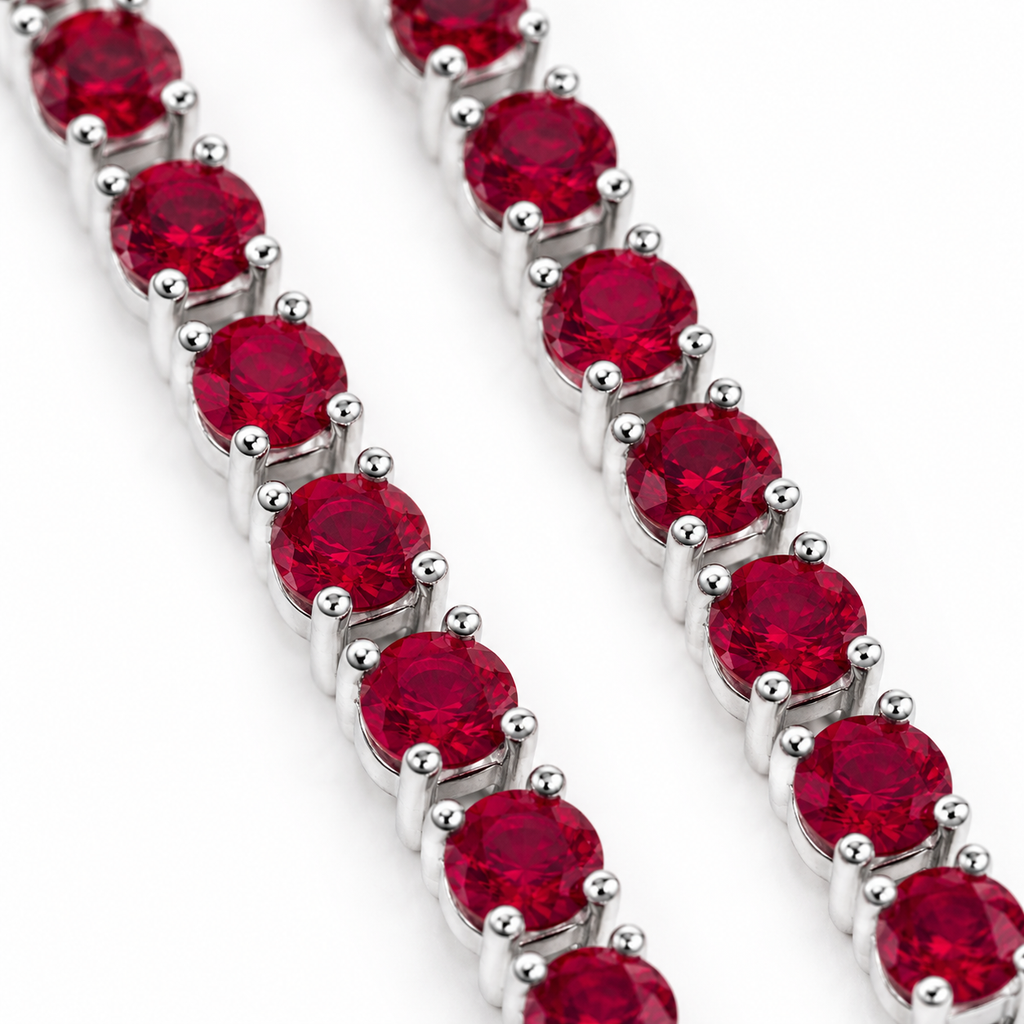 Macro view of 3mm round deep crimson red ruby gemstones in Phimsera sterling silver dangle earrings