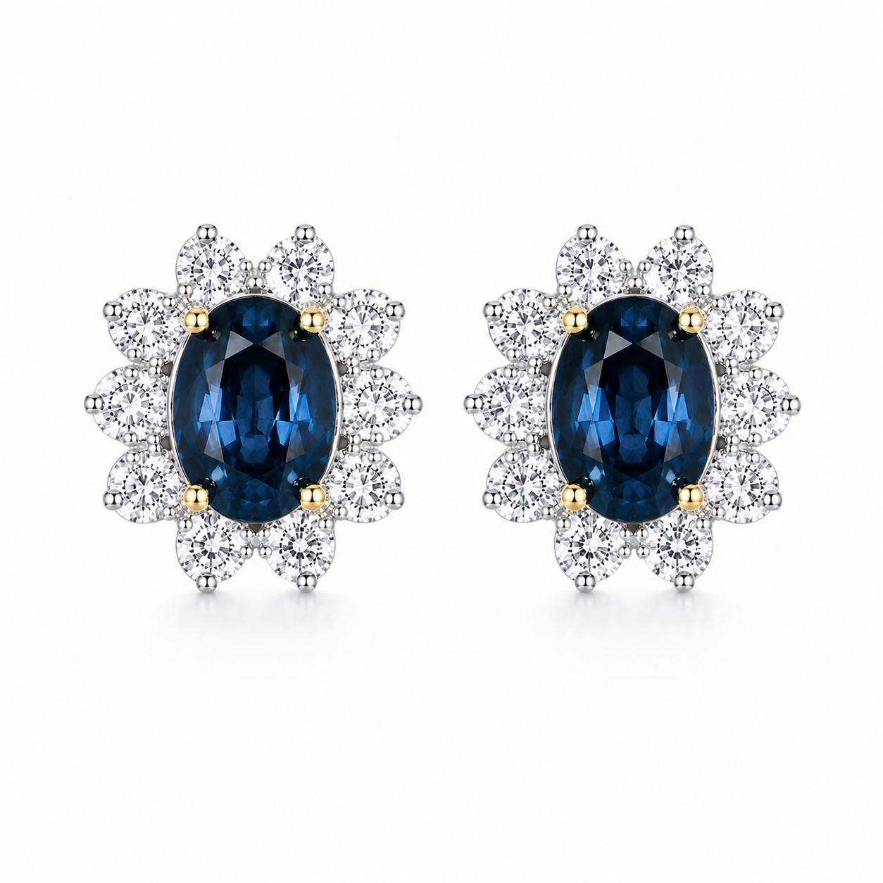 Natural 5x7mm oval London Blue Topaz halo stud earrings in platinum plated sterling silver with cubic zirconia on a white background.
