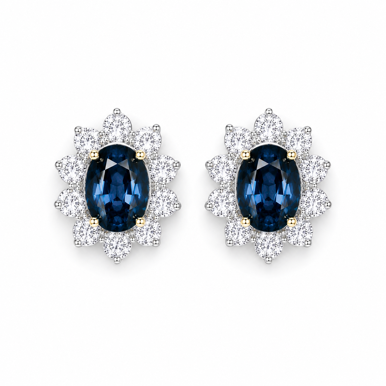 Natural 5x7mm oval London Blue Topaz halo stud earrings in platinum plated sterling silver with cubic zirconia on a white background.