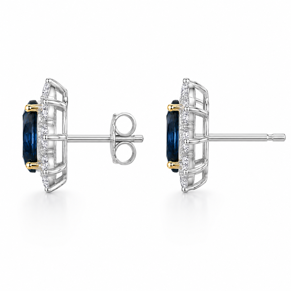 Natural 5x7mm oval London Blue Topaz halo stud earrings in platinum plated sterling silver with cubic zirconia on a white background.