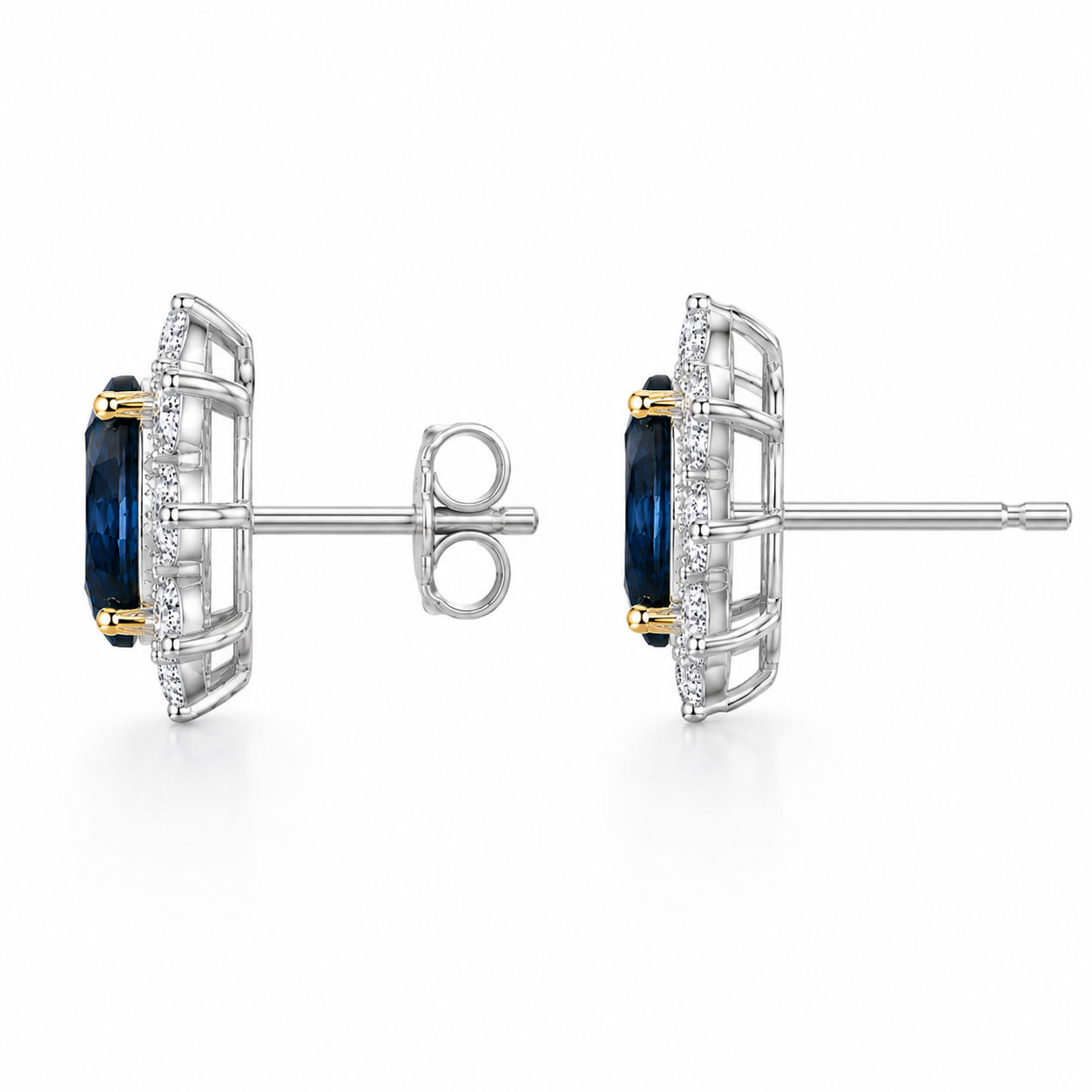 Natural 5x7mm oval London Blue Topaz halo stud earrings in platinum plated sterling silver with cubic zirconia on a white background.