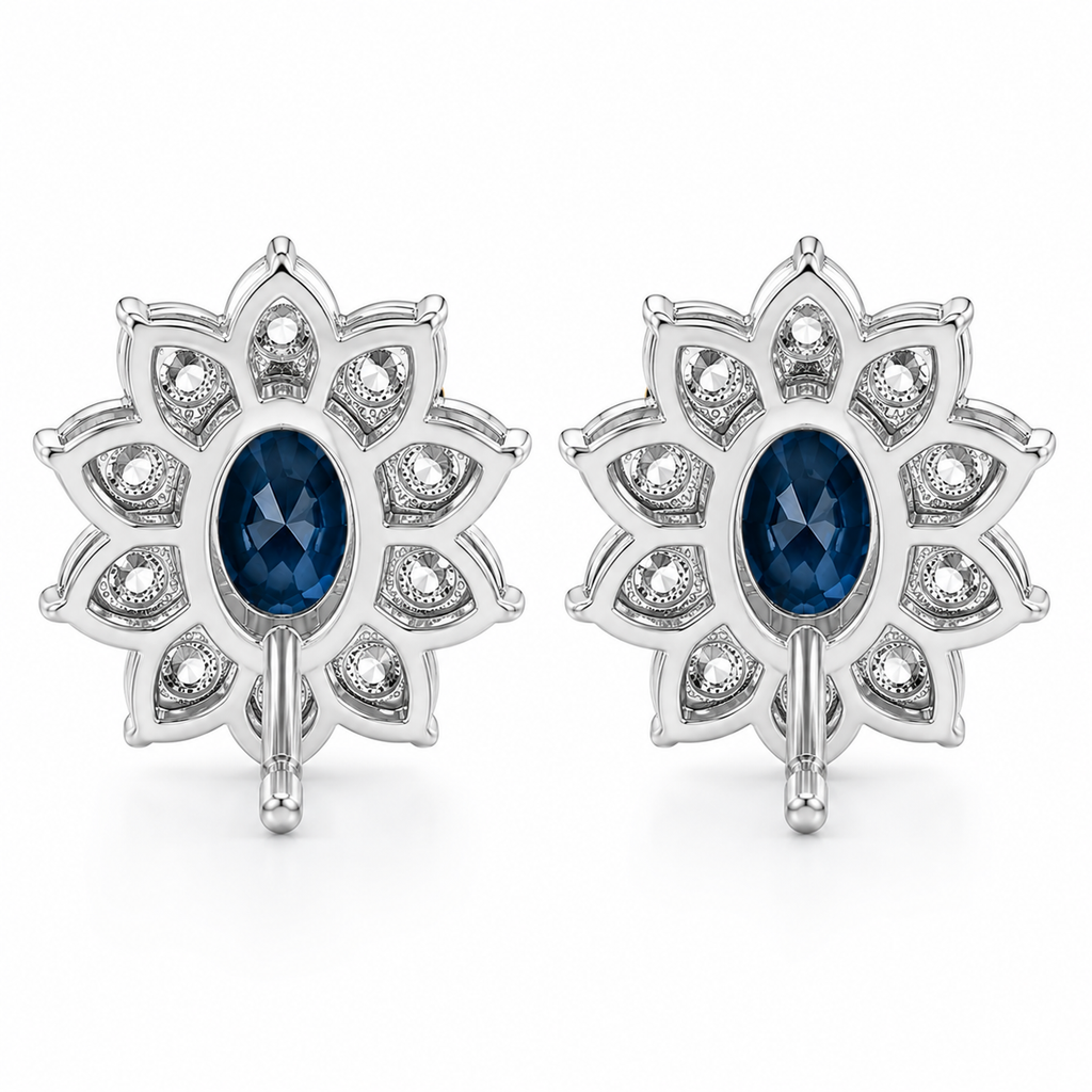Natural 5x7mm oval London Blue Topaz halo stud earrings in platinum plated sterling silver with cubic zirconia on a white background.