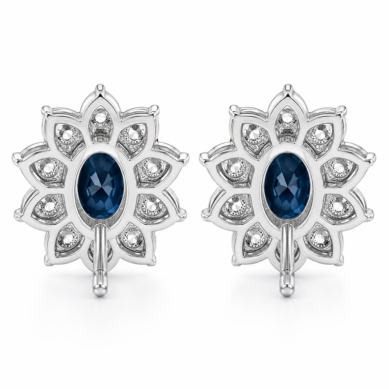Natural 5x7mm oval London Blue Topaz halo stud earrings in platinum plated sterling silver with cubic zirconia on a white background.