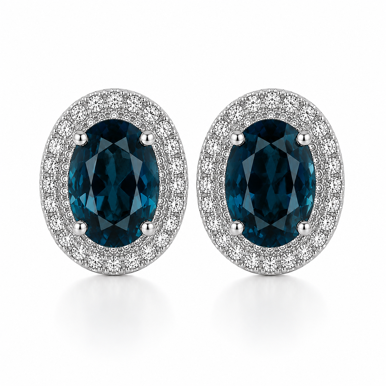 Natural London Blue Topaz oval stud earrings with 5x7mm gemstones, double halo cubic zirconia, platinum-plated 925 sterling silver, front view.