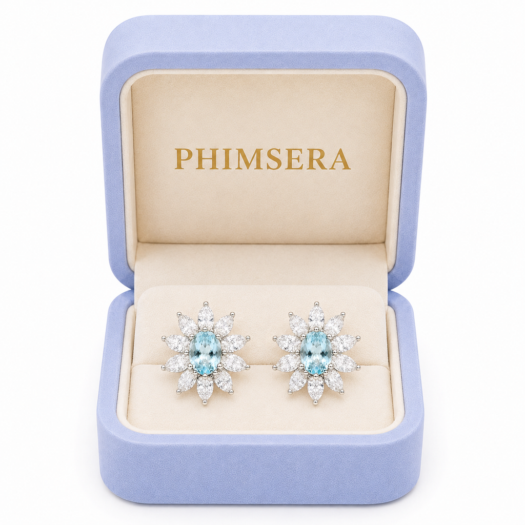 Natural 4x6mm aquamarine stud earrings displayed inside a luxury Phimsera gift box with soft ivory velvet interior