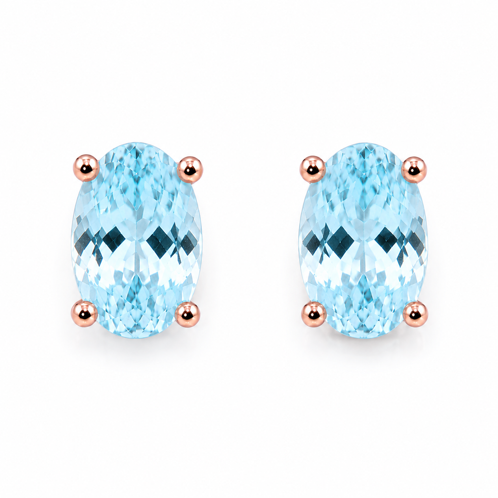 Natural 4x6mm oval aquamarine stud earrings in 925 sterling silver on a white background