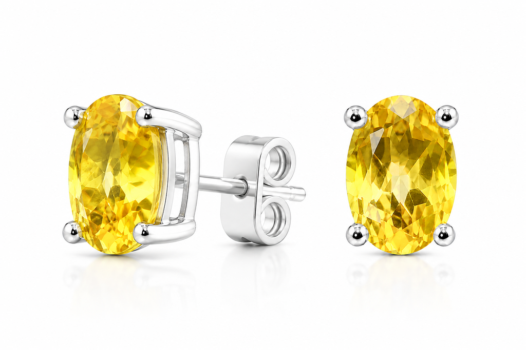 Natural oval citrine solitaire stud earrings shown at a 45 degree angle in platinum plated sterling silver