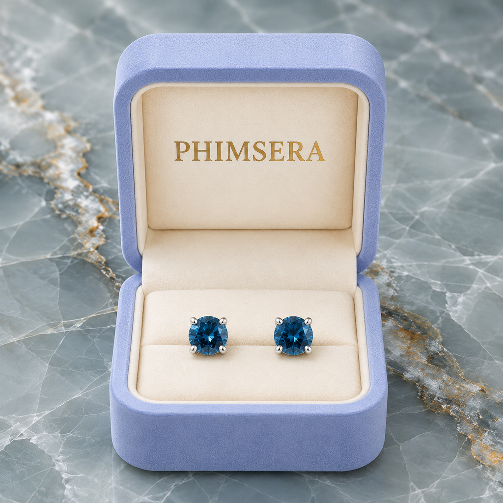 5mm round London Blue Topaz stud earrings in solid 925 sterling silver with four-prong settings on a white background