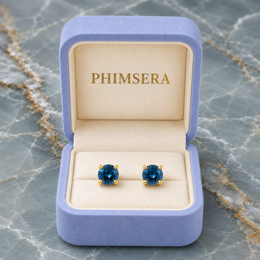 5mm round London Blue Topaz stud earrings in solid 925 sterling silver with four-prong settings on a white background
