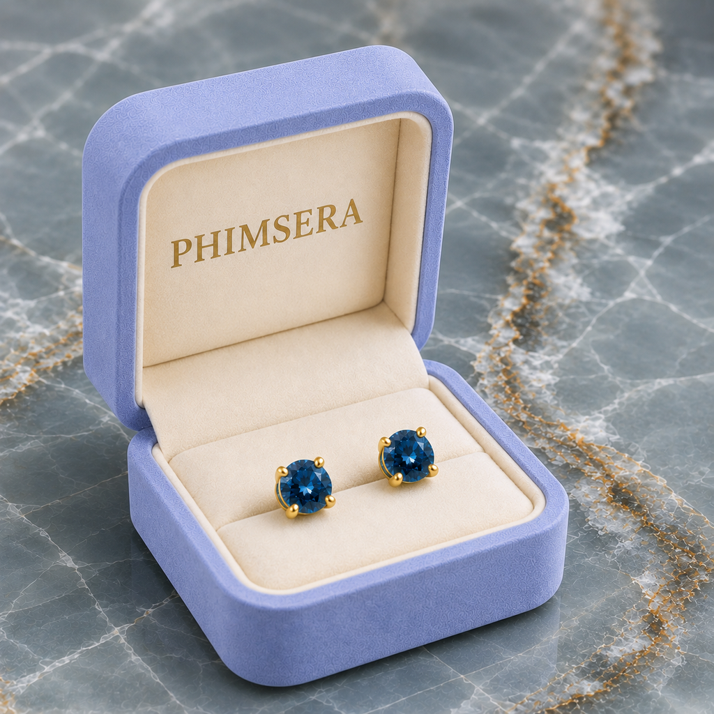 5mm round London Blue Topaz stud earrings in solid 925 sterling silver with four-prong settings on a white background