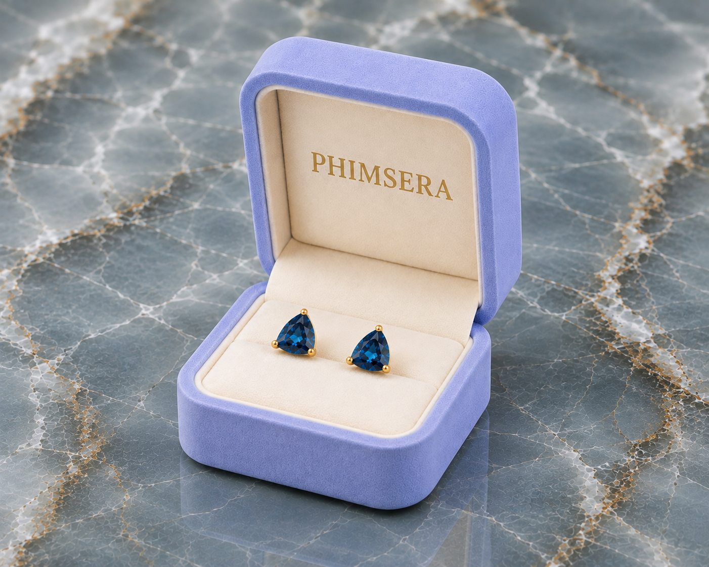 Natural 7mm trillion-cut London Blue Topaz stud earrings in solid 925 sterling silver with classic three-prong settings on a white background