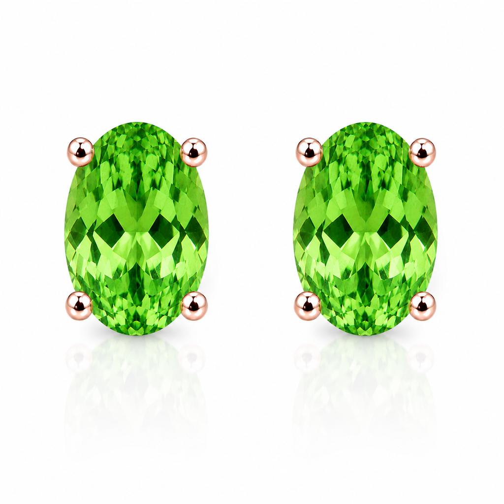 Natural 4x6mm oval tsavorite garnet stud earrings in 925 sterling silver solitaire setting on white background