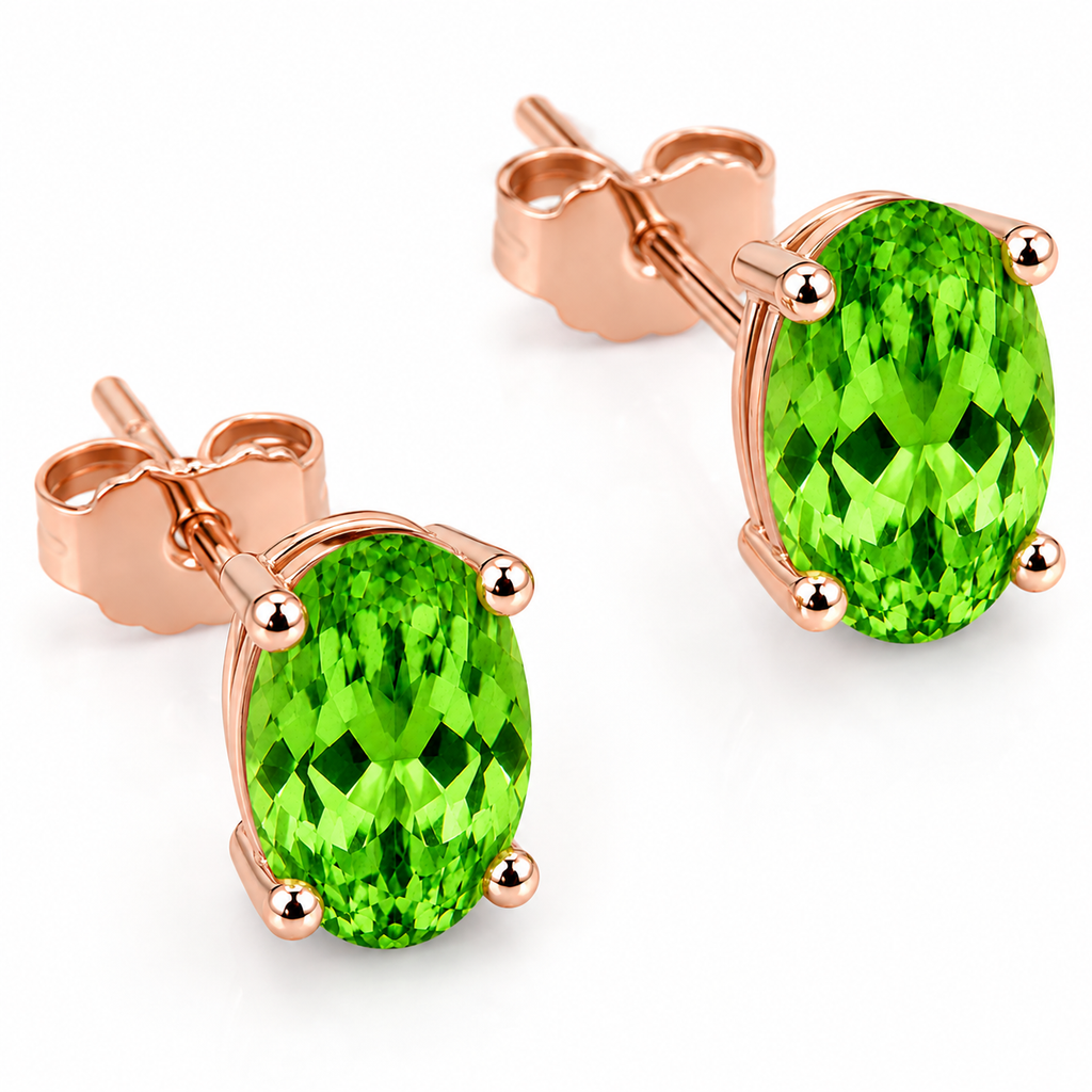 Macro close-up of natural vivid green 4x6mm oval tsavorite garnet earrings showing gemstone brilliance and facet detail