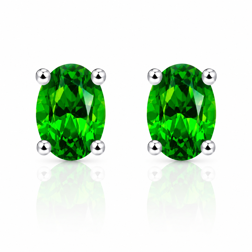 Natural 4x6mm oval chrome diopside stud earrings in 925 sterling silver on white background
