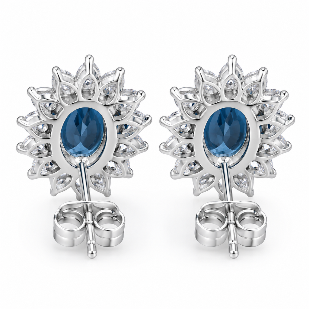 Natural 6x8mm oval London Blue Topaz halo stud earrings in solid 925 sterling silver, available in platinum, yellow gold, or rose gold finish, presented in a PHIMSERA gift box.