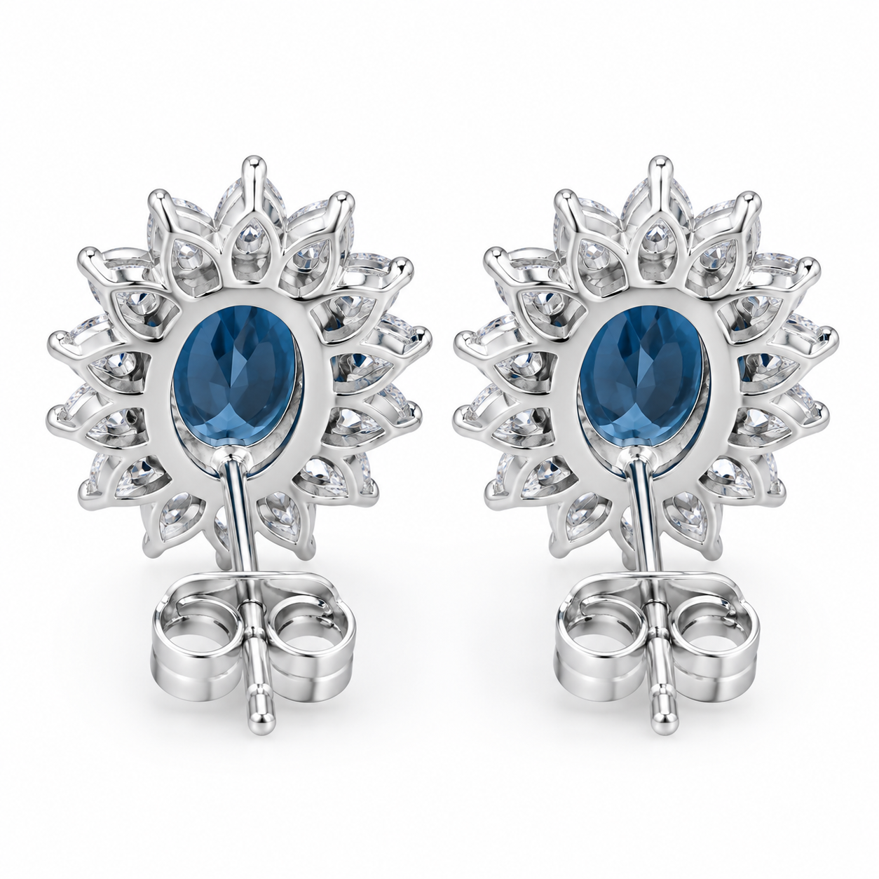 Natural 6x8mm oval London Blue Topaz halo stud earrings in solid 925 sterling silver, available in platinum, yellow gold, or rose gold finish, presented in a PHIMSERA gift box.
