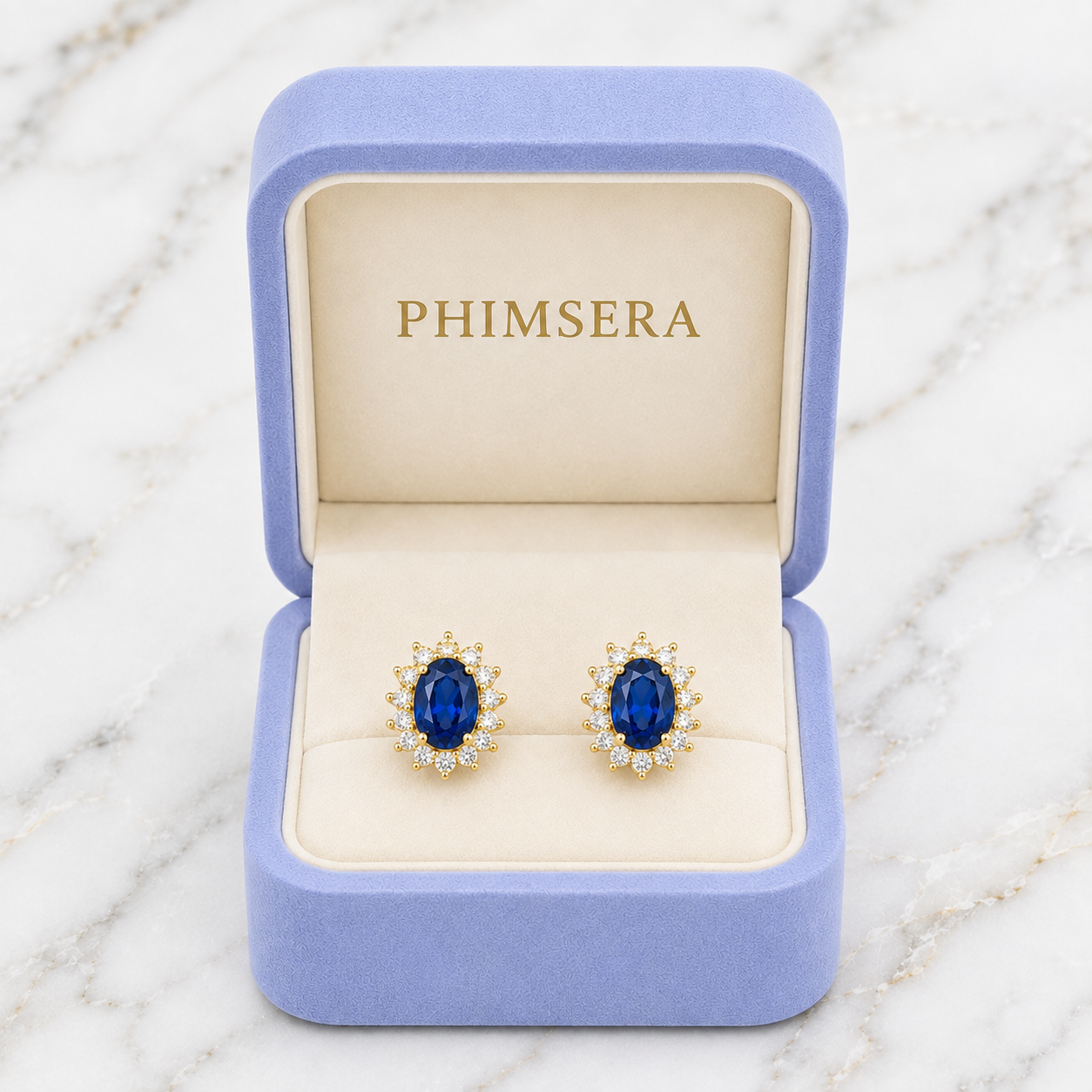 Natural 6x8mm oval London Blue Topaz halo stud earrings in solid 925 sterling silver, available in platinum, yellow gold, or rose gold finish, presented in a PHIMSERA gift box.