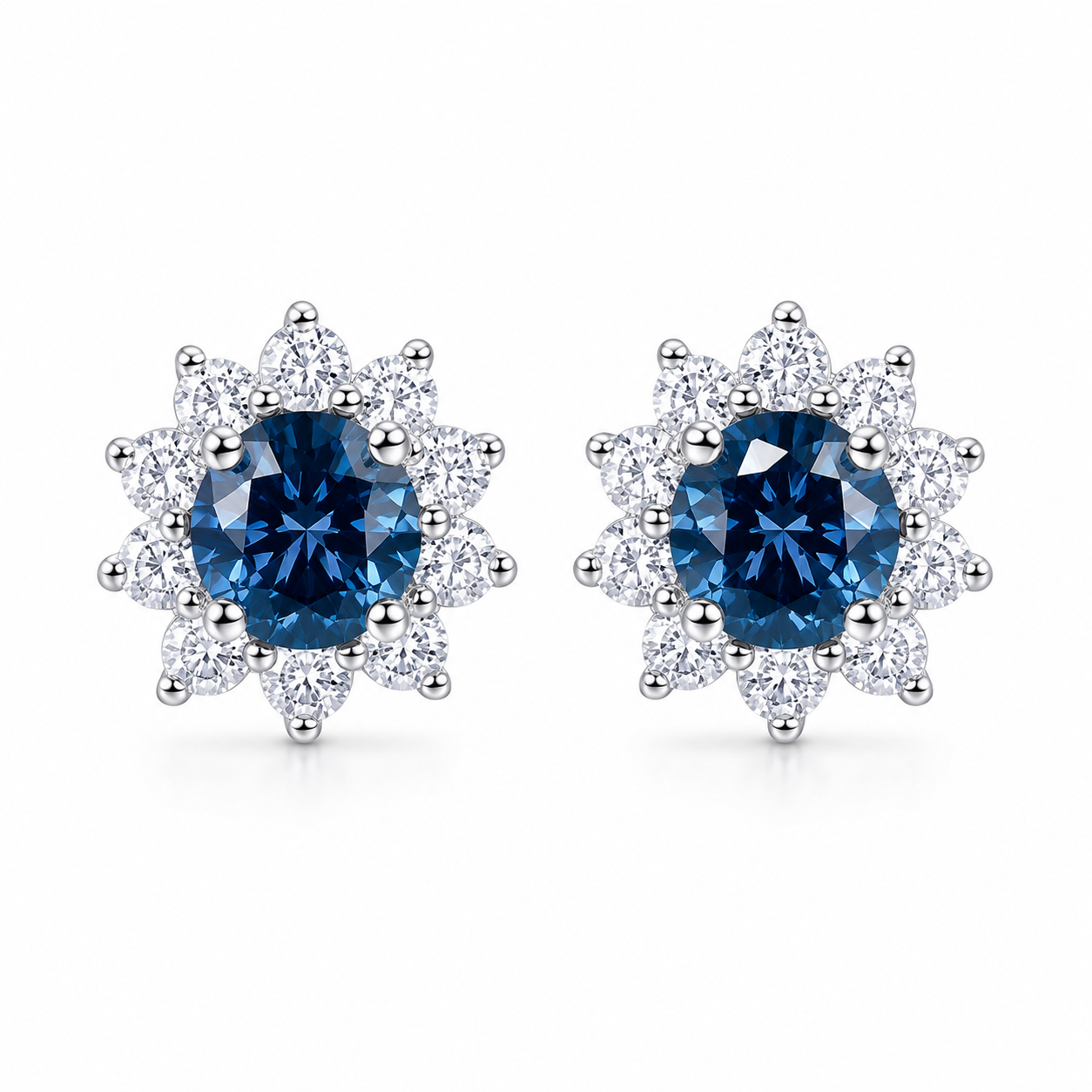 PHIMSERA Natural 5mm round London Blue Topaz floral halo stud earrings in solid 925 sterling silver with platinum plating, available in yellow gold or rose gold plating, presented in a PHIMSERA gift box.