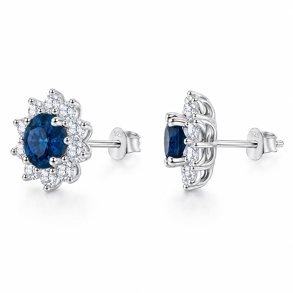 PHIMSERA Natural 5mm round London Blue Topaz floral halo stud earrings in solid 925 sterling silver with platinum plating, available in yellow gold or rose gold plating, presented in a PHIMSERA gift box.