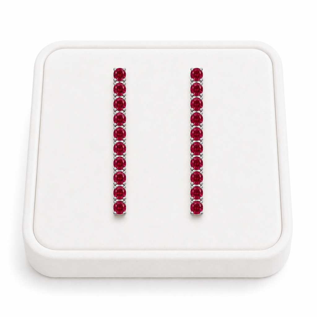 Phimsera natural ruby dangle earrings displayed on a white velvet jewelry tray against a bright white background