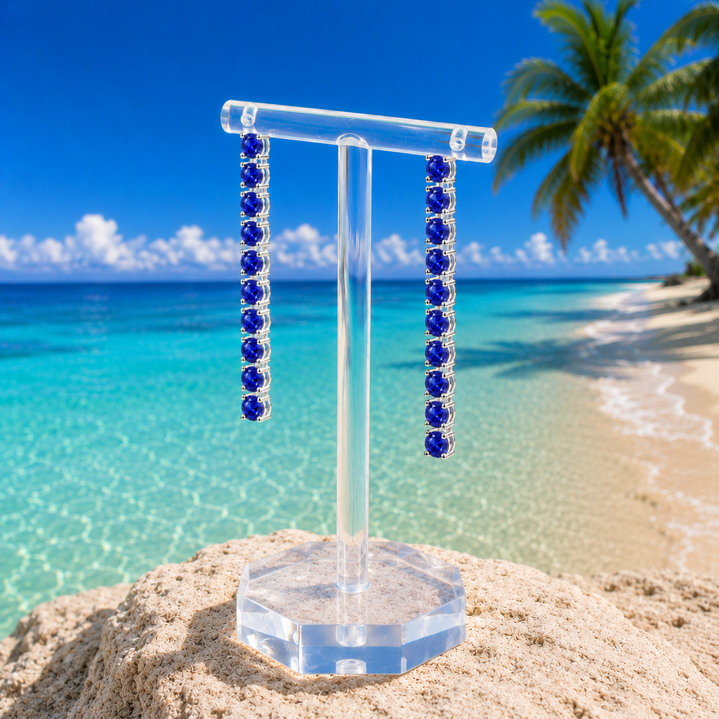 Phimsera natural blue sapphire dangle earrings styled in a bright beach lifestyle setting