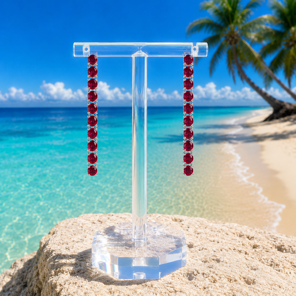 Phimsera natural red ruby dangle earrings styled in an elegant beach lifestyle setting