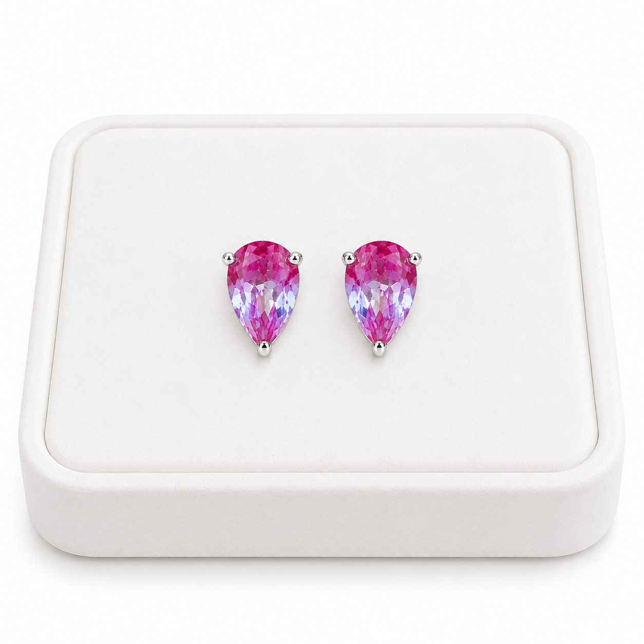 4x6mm pear cut lab created alexandrite stud earrings displayed on a white velvet jewelry tray