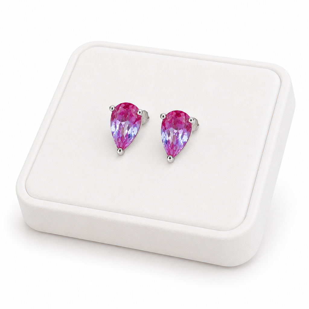 4x6mm color changing lab alexandrite stud earrings displayed on a white jewelry tray at an angle