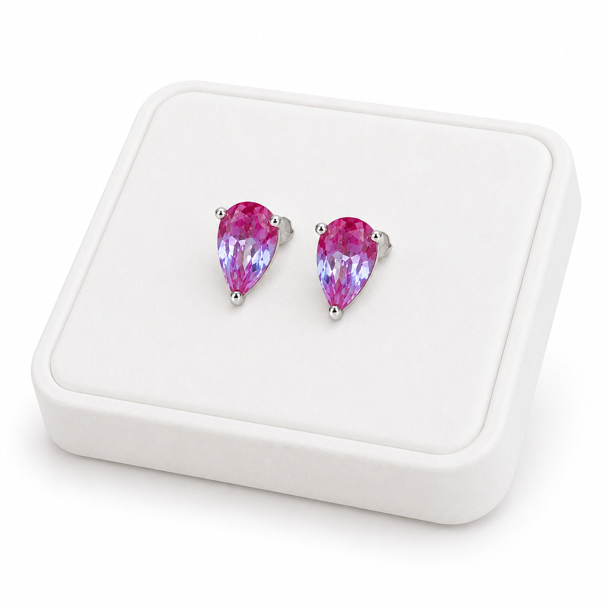 4x6mm color changing lab alexandrite stud earrings displayed on a white jewelry tray at an angle