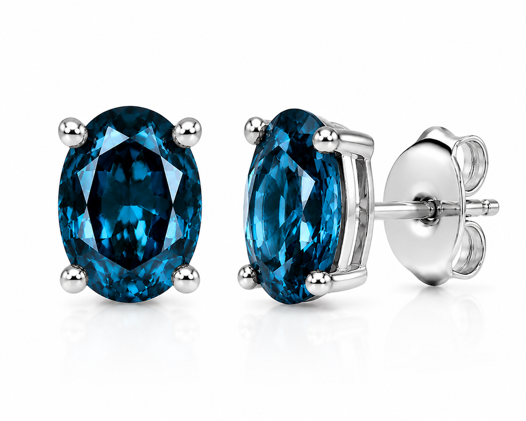 Natural 4x6mm oval London Blue Topaz solitaire stud earrings in 925 sterling silver with platinum plated finish