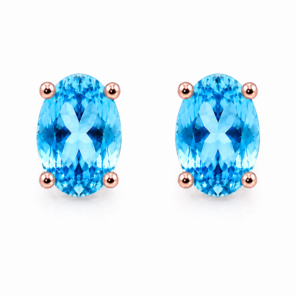 Natural 4x6mm oval Swiss Blue Topaz solitaire stud earrings in Rose Gold Plated 925 sterling silver on a white background