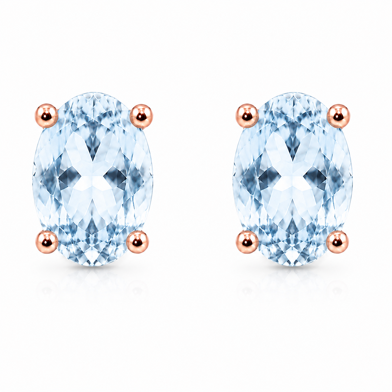 Natural 4x6mm oval Sky Blue Topaz solitaire stud earrings in Rose Gold Plated 925 sterling silver on a white background
