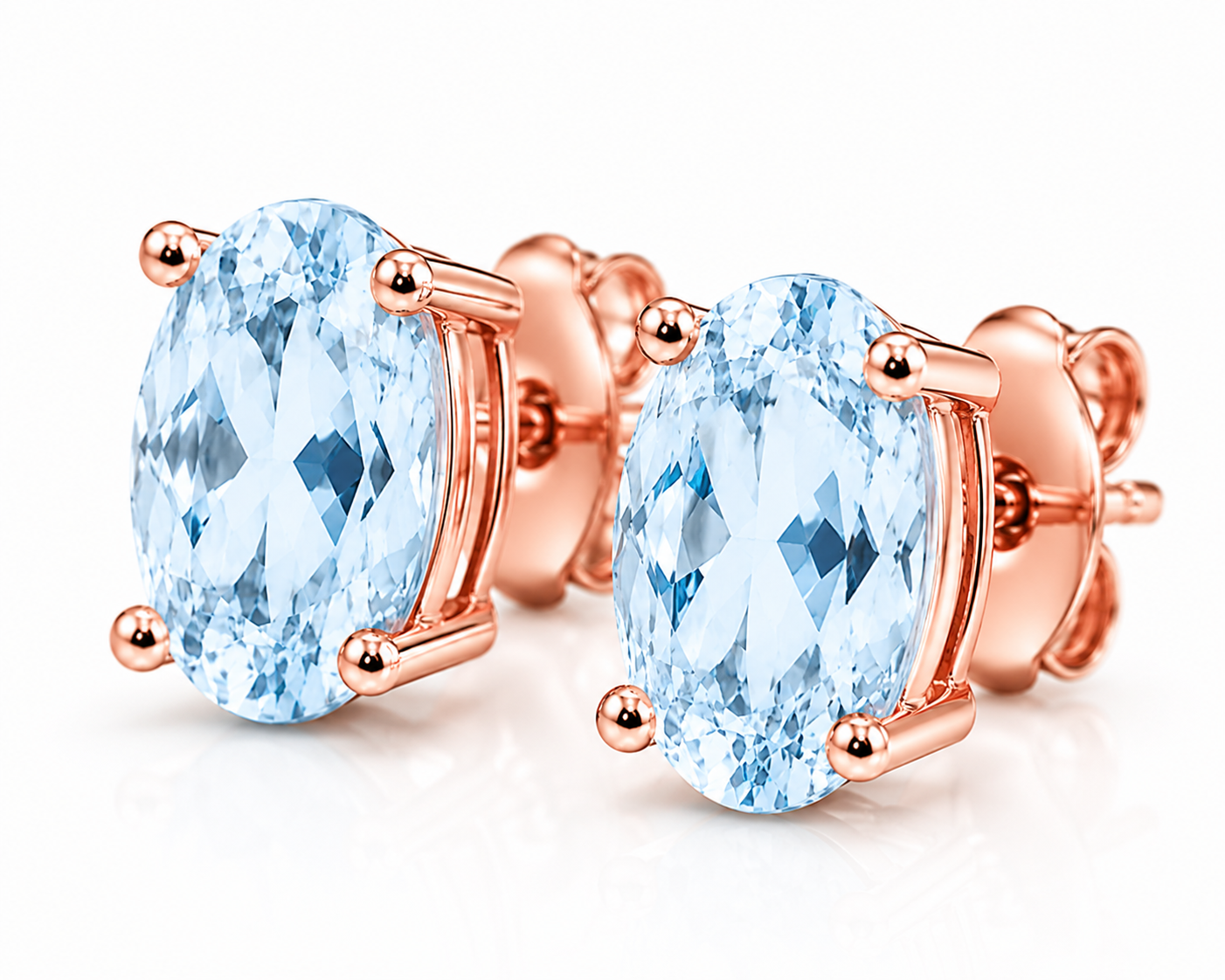 Macro close-up of natural 4x6mm Sky Blue Topaz earrings with pale blue facets and polished Rose Gold Plated settings