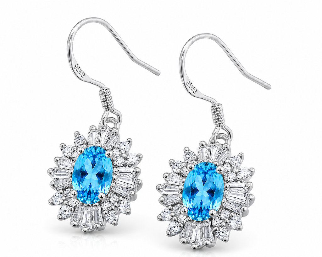 Swiss Blue Topaz floral dangle earrings shown at an angle with sparkling mixed-shape cubic zirconia halos and silver fishhooks